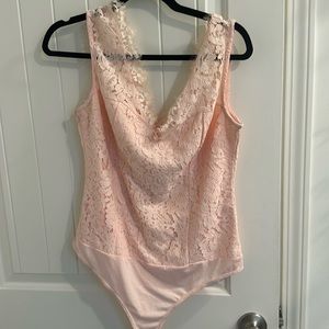 Lace v neck body suit in cream ish pink color I believe Eva mendes for NYCo